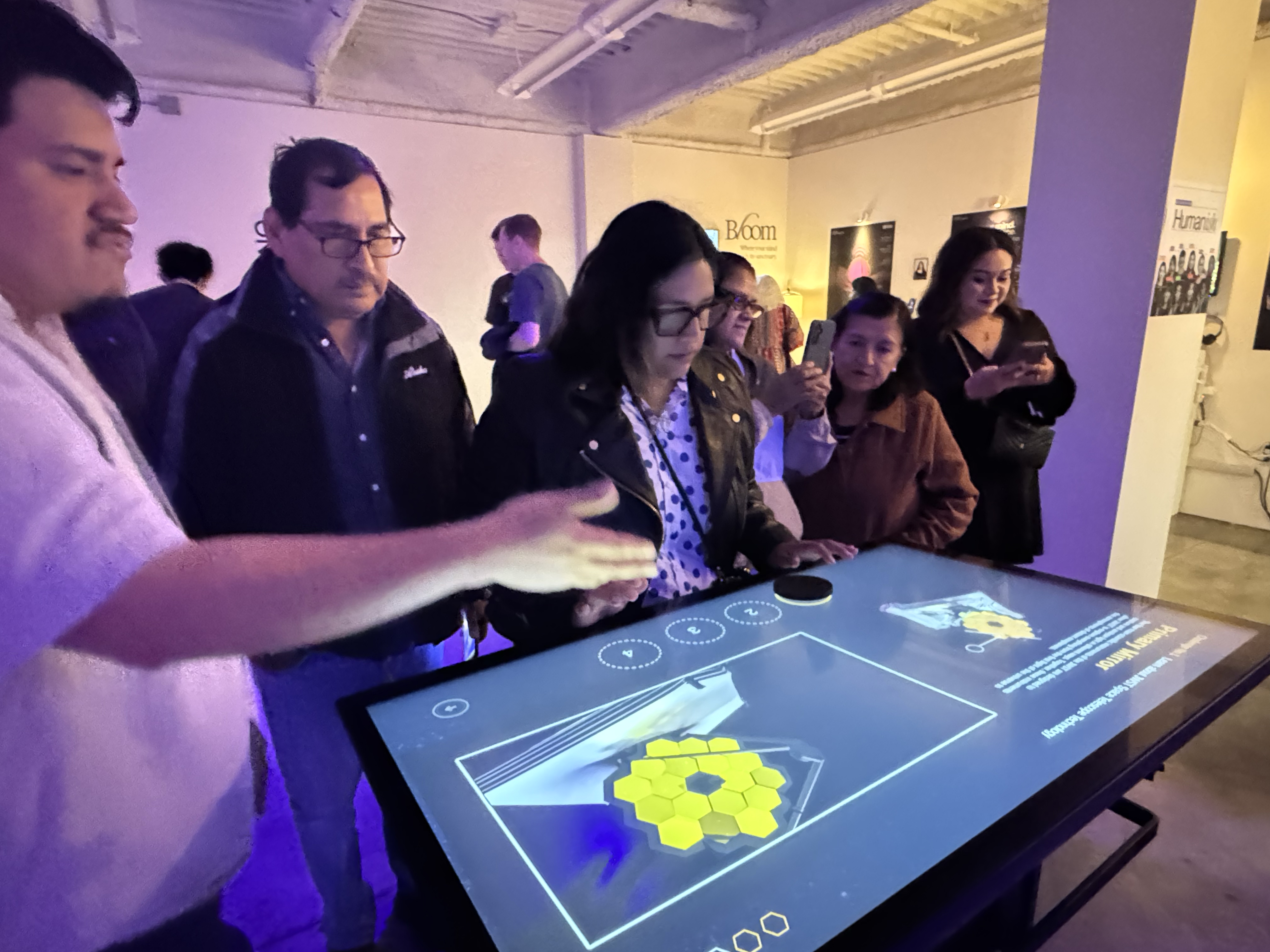 Visitors engage with a student thesis project at the BFA Interaction Design showcase, Spring 2025.