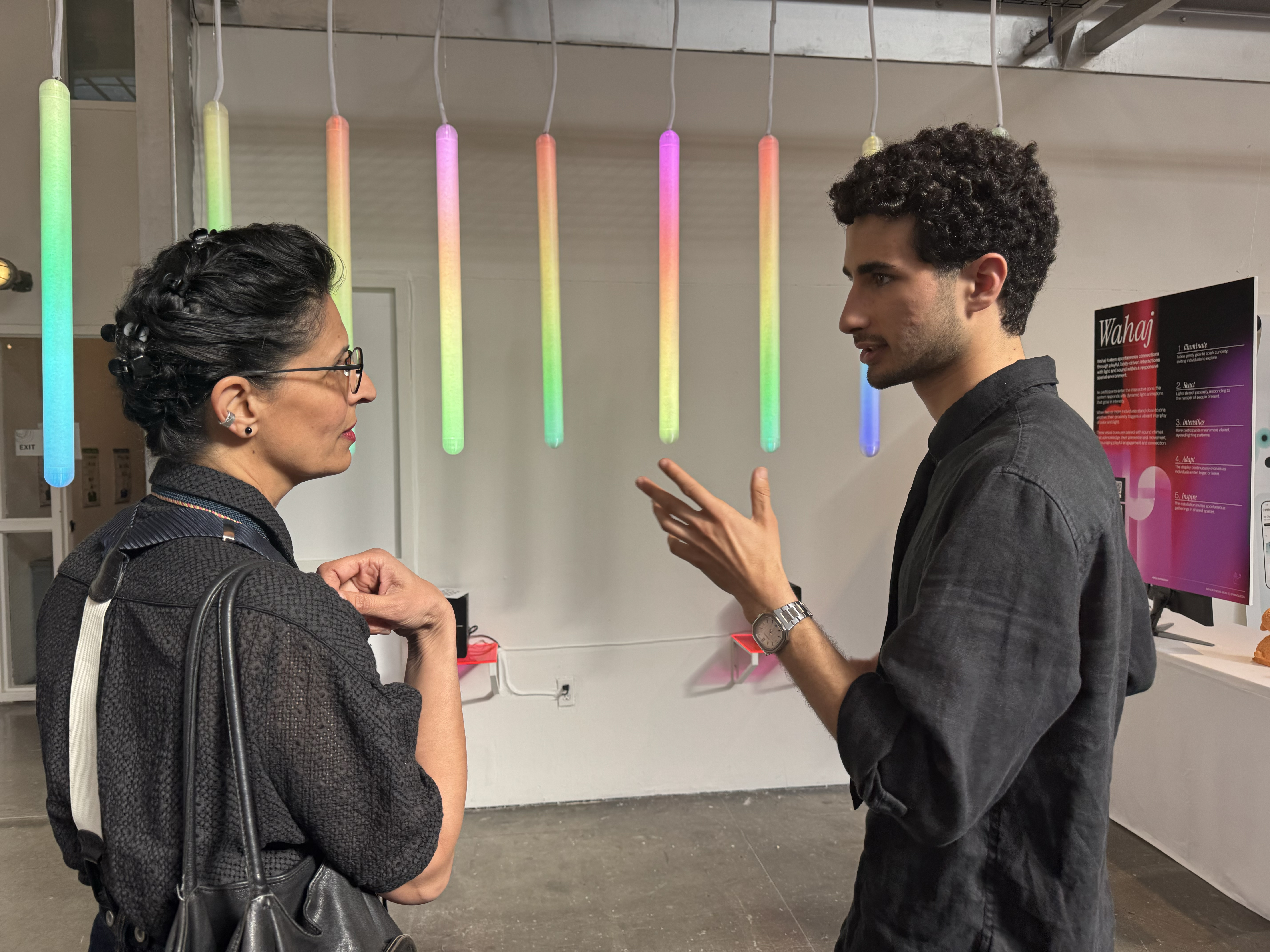 Visitors engage with a student thesis project at the BFA Interaction Design showcase, Spring 2025.