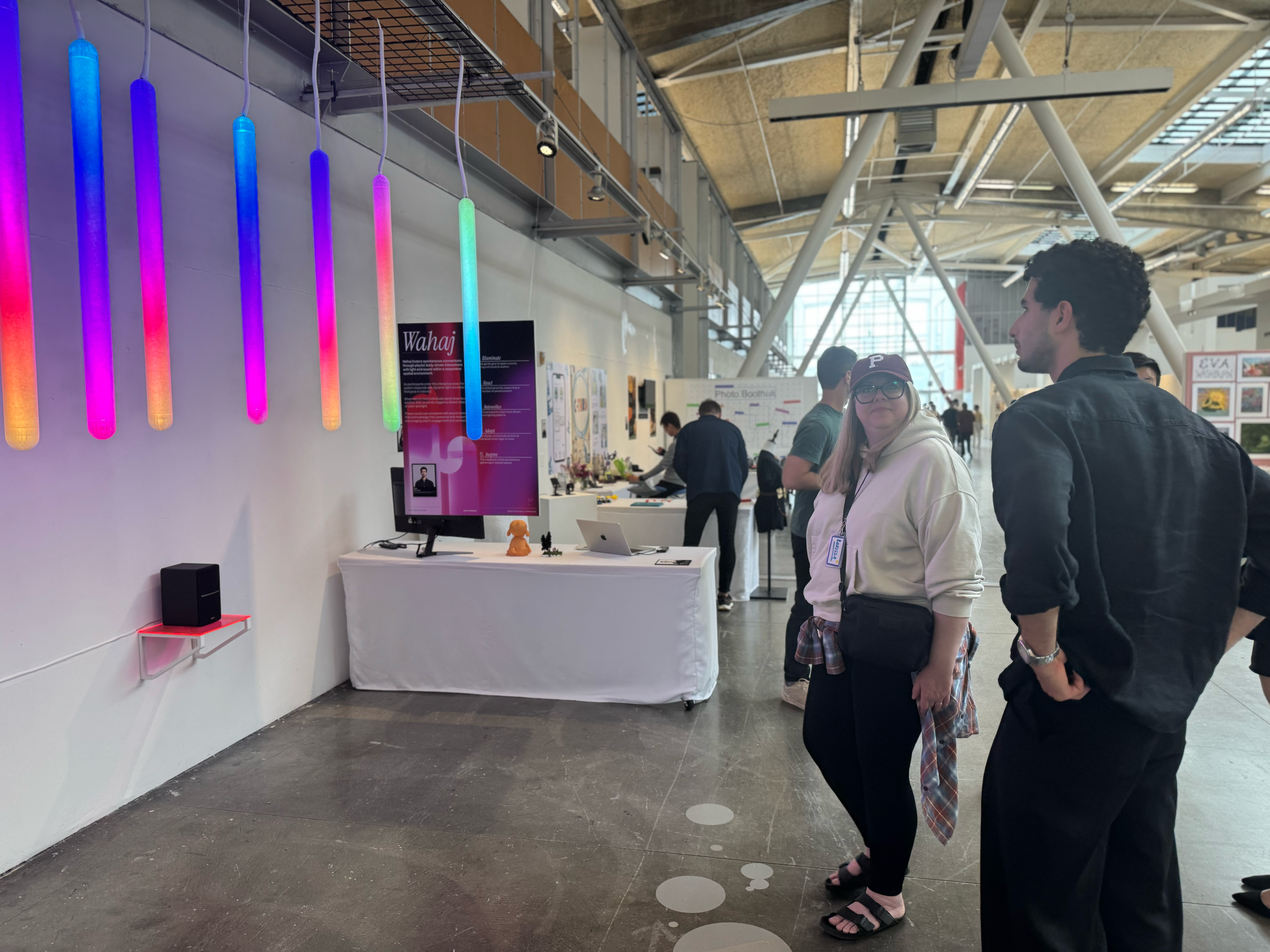 Visitors engage with a student thesis project at the BFA Interaction Design showcase, Spring 2025.